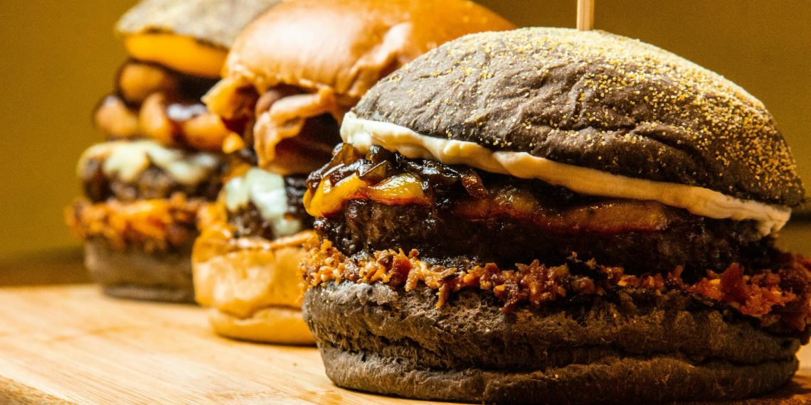 burgers on brown wooden chopping board