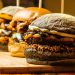 burgers on brown wooden chopping board