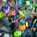 green chain link fence with assorted color padlocks